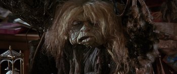 Movie still from “Labyrinth” (1986), directed by Jim Henson – The face of a person with long hair; Close Up shot, Low angle