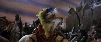 Movie still from “Labyrinth” (1986), directed by Jim Henson – A dog wearing a hat with feathers on it's head; Close Up shot, Low angle