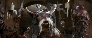Movie still from “Labyrinth” (1986), directed by Jim Henson – A person wearing a costume with horns; Close Up shot, High angle