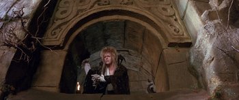 Movie still from “Labyrinth” (1986), directed by Jim Henson – Jareth the goblin king in the labyrinth movie; Medium shot, Low angle