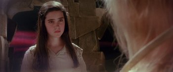 Movie still from “Labyrinth” (1986), directed by Jim Henson – A young girl is looking at the camera; Close Up shot, Over the shoulder angle