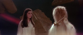 Movie still from “Labyrinth” (1986), directed by Jim Henson – A young girl standing in front of a rock; Medium shot, Over the shoulder angle