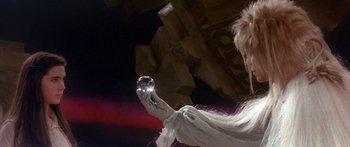 Movie still from “Labyrinth” (1986), directed by Jim Henson – A woman holding a crystal ball in her hand; Close Up shot, Low angle