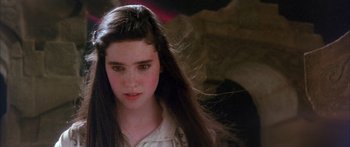 Movie still from “Labyrinth” (1986), directed by Jim Henson – A woman with long black hair is looking at the camera; Close Up shot, Over the shoulder angle