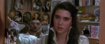 Movie still from “Labyrinth” (1986), directed by Jim Henson – A young woman in front of a stuffed animal display; Close Up shot, Over the shoulder angle