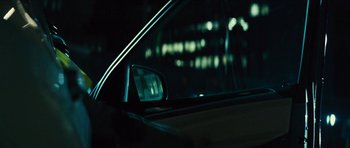 Movie still from “Locke” (2013), directed by Steven Knight – The side view mirror of a car at night time; Close Up shot, Over the shoulder angle