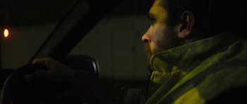 Movie still from “Locke” (2013), directed by Steven Knight – A man sitting in the driver's seat of a car; Close Up shot, Over the shoulder angle