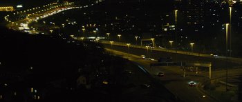Movie still from “Locke” (2013), directed by Steven Knight – A view of a city at night from a bridge; Extreme Wide shot, High angle