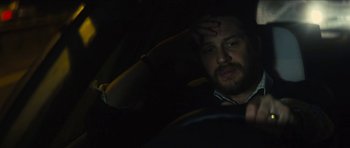 Movie still from “Locke” (2013), directed by Steven Knight – A man sitting in the driver's seat of a car at night; Close Up shot, Over the shoulder angle