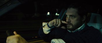 Movie still from “Locke” (2013), directed by Steven Knight – A man sitting in a car with his hand on his face; Close Up shot, Over the shoulder angle