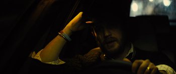 Movie still from “Locke” (2013), directed by Steven Knight – A man sitting in the driver's seat of a car; Close Up shot, Over the shoulder angle