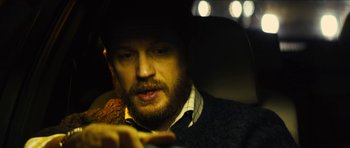 Movie still from “Locke” (2013), directed by Steven Knight – A person holding a cell phone; Close Up shot, High angle