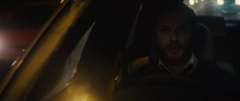 Movie still from “Locke” (2013), directed by Steven Knight – A man sitting in the back seat of a car at night; Close Up shot, Over the shoulder angle