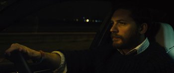 Movie still from “Locke” (2013), directed by Steven Knight – A man sitting in the driver's seat of a car at night; Close Up shot, Over the shoulder angle