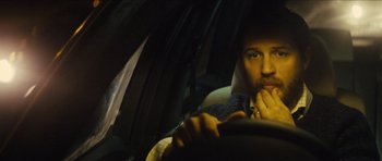 Movie still from “Locke” (2013), directed by Steven Knight – A man sitting in the driver's seat of a car; Close Up shot, Over the shoulder angle