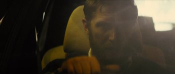 Movie still from “Locke” (2013), directed by Steven Knight – A bearded man sitting in the back seat of a car; Close Up shot, Over the shoulder angle