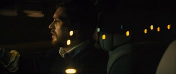 Movie still from “Locke” (2013), directed by Steven Knight – A man sitting in a car at night with lights on; Close Up shot, Over the shoulder angle