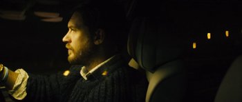 Movie still from “Locke” (2013), directed by Steven Knight – A man sitting in the back seat of a car; Close Up shot, Over the shoulder angle
