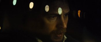 Movie still from “Locke” (2013), directed by Steven Knight – A person looking at the camera; Close Up shot, Over the shoulder angle