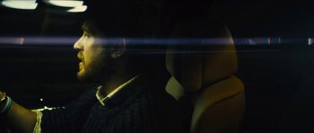 Movie still from “Locke” (2013), directed by Steven Knight – A man sitting in the back seat of a car; Extreme Close Up shot, Low angle