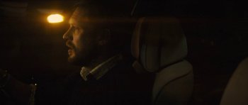 Movie still from “Locke” (2013), directed by Steven Knight – A man sitting in the back seat of a car; Close Up shot, Over the shoulder angle