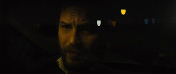 Movie still from “Locke” (2013), directed by Steven Knight – A person in a car at night; Close Up shot, Over the shoulder angle
