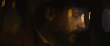Movie still from “Locke” (2013), directed by Steven Knight – A man's face in a dark room; Extreme Close Up shot, Over the shoulder angle