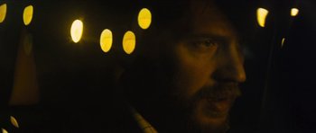 Movie still from “Locke” (2013), directed by Steven Knight – A man with a beard is looking into the camera; Extreme Close Up shot, Low angle