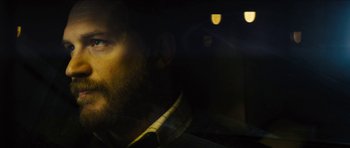 Movie still from “Locke” (2013), directed by Steven Knight – A person in a car at night; Close Up shot, Over the shoulder angle