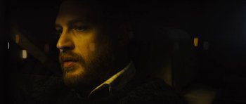 Movie still from “Locke” (2013), directed by Steven Knight – A person wearing a jacket; Close Up shot, High angle