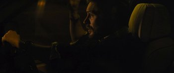 Movie still from “Locke” (2013), directed by Steven Knight – A person in a dark room; Close Up shot, Over the shoulder angle