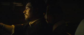 Movie still from “Locke” (2013), directed by Steven Knight – A man sitting in the back of a vehicle; Close Up shot, Over the shoulder angle