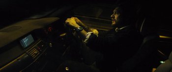 Movie still from “Locke” (2013), directed by Steven Knight – A man sitting in the driver's seat of a car; Medium shot, High angle