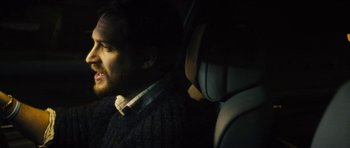 Movie still from “Locke” (2013), directed by Steven Knight – A man sitting in the back seat of a car; Close Up shot, Over the shoulder angle