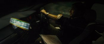 Movie still from “Locke” (2013), directed by Steven Knight – A man sitting in the driver's seat of a car at night; Close Up shot, High angle