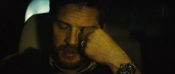 Movie still from “Locke” (2013), directed by Steven Knight – A person holding his hand up to his face; Close Up shot, High angle