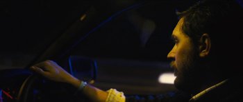 Movie still from “Locke” (2013), directed by Steven Knight – A person is sitting in a car in the dark; Close Up shot, Over the shoulder angle