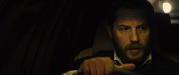 Movie still from “Locke” (2013), directed by Steven Knight – A man driving in a car at night; Close Up shot, Over the shoulder angle
