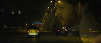 Movie still from “Locke” (2013), directed by Steven Knight – A man's face is shown in the middle of the road; Close Up shot, Over the shoulder angle