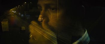 Movie still from “Locke” (2013), directed by Steven Knight – A man is looking out of a window at night; Extreme Close Up shot, Low angle