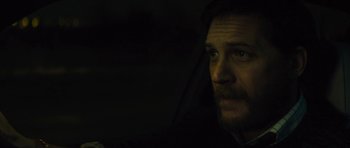 Movie still from “Locke” (2013), directed by Steven Knight – A person sitting in a car at night; Close Up shot, Low angle