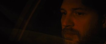 Movie still from “Locke” (2013), directed by Steven Knight – A person's face in a car window; Close Up shot, Over the shoulder angle