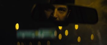 Movie still from “Locke” (2013), directed by Steven Knight – A man looking out of a car window at night; Close Up shot, Over the shoulder angle
