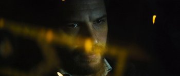 Movie still from “Locke” (2013), directed by Steven Knight – A person's face with a blurry background; Extreme Close Up shot, Over the shoulder angle
