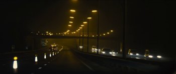Movie still from “Locke” (2013), directed by Steven Knight – Cars are driving down a highway at night; Extreme Wide shot, Low angle