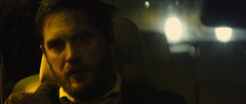 Movie still from “Locke” (2013), directed by Steven Knight – A man sitting in the back seat of a car; Close Up shot, Over the shoulder angle