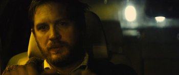 Movie still from “Locke” (2013), directed by Steven Knight – A person in a car looking at the camera; Close Up shot, Over the shoulder angle
