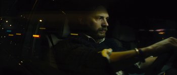 Movie still from “Locke” (2013), directed by Steven Knight – A man sitting in the back seat of a car; Close Up shot, Over the shoulder angle