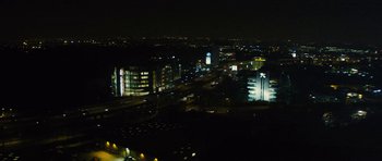 Movie still from “Locke” (2013), directed by Steven Knight – An aerial view of a city at night with lights on; Extreme Wide shot, High angle