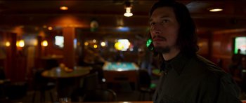 Movie still from “Logan Lucky” (2017), directed by Steven Soderbergh – A man with long hair and a goatee is in a room with a pool table; Close Up shot, Over the shoulder angle